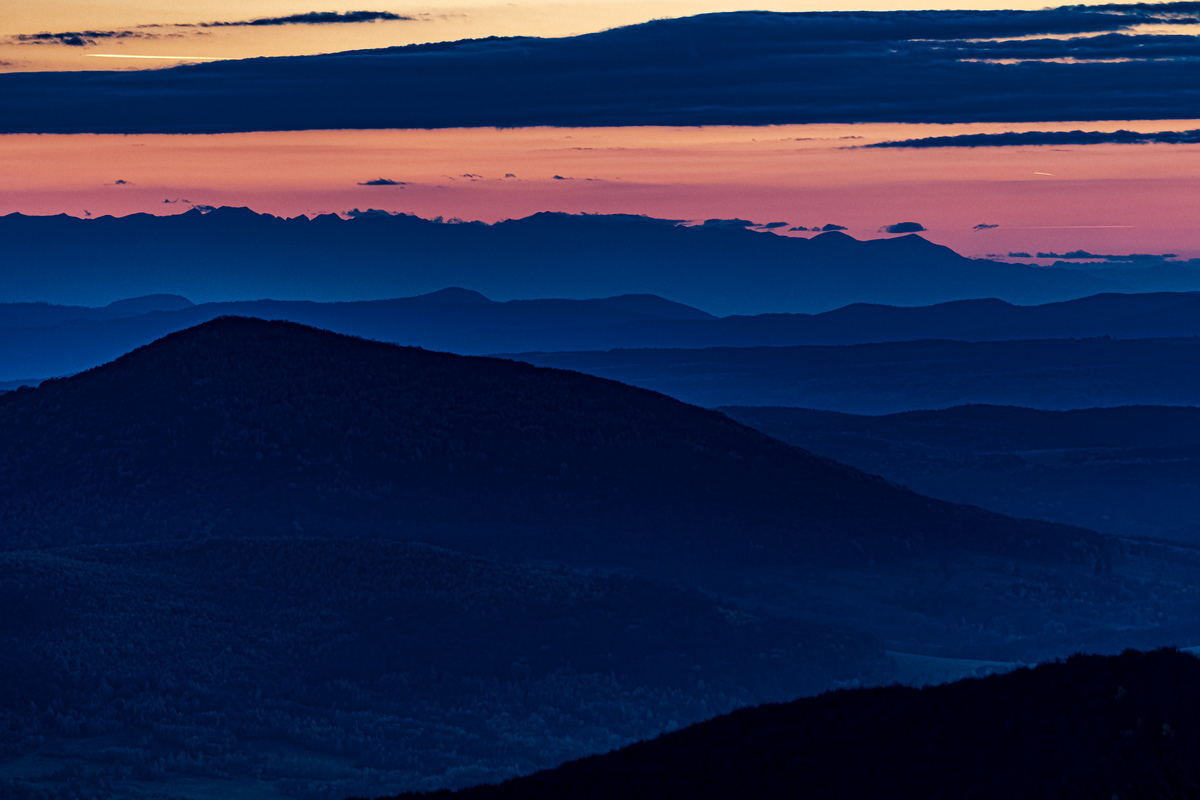 Blue clock above the valley