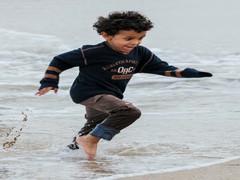 Children playing in the waves in the sea waves