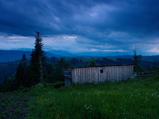 mountain landscape with wooden barn