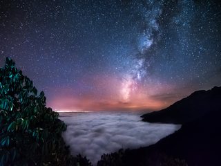 Milky Way above the clouds ocean