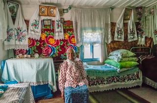 Old Woman in the Traditional Volyn Wooden House