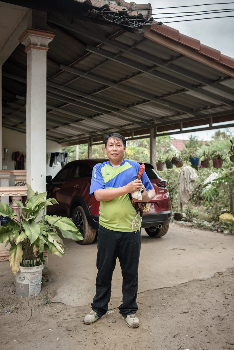 Portrait of an owner with his fighting rooster