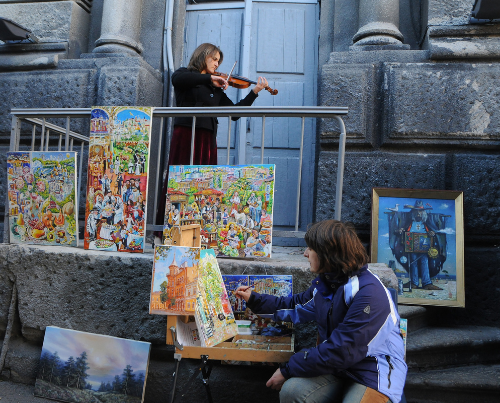 Художница рисует пейзаж под звуки скрипки