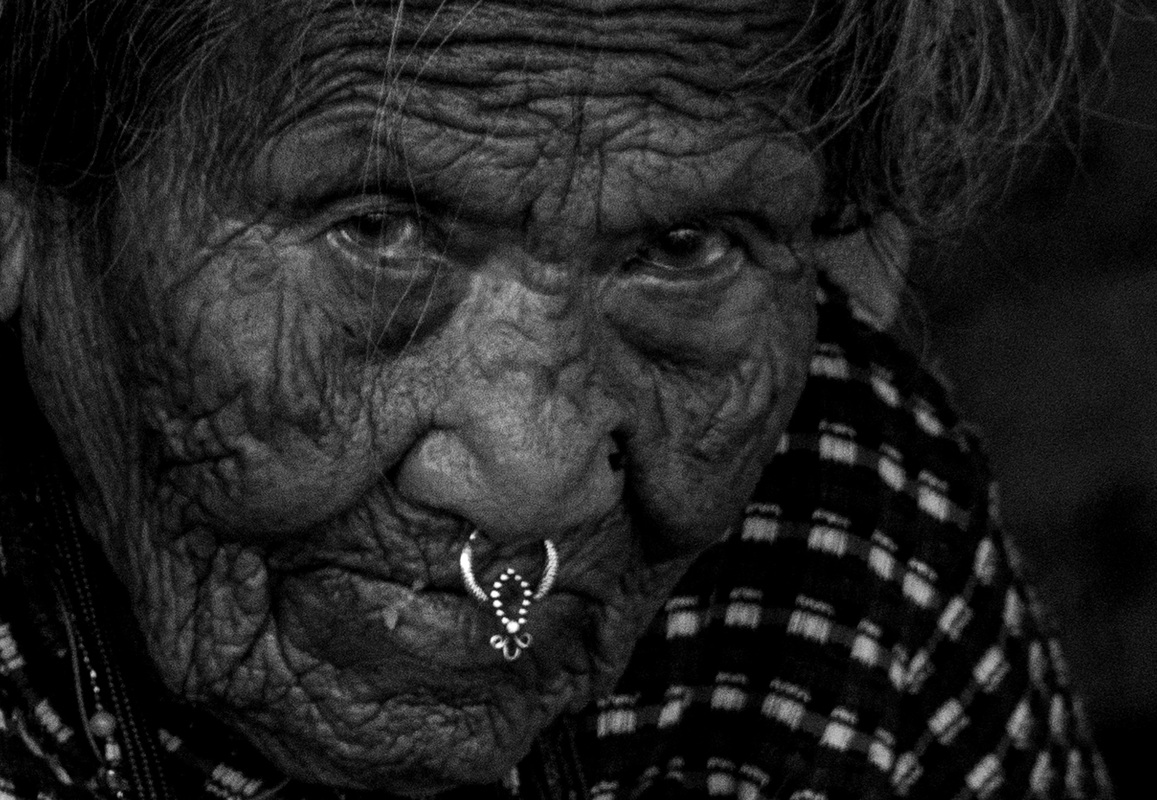 -The old woman wearing nose ring